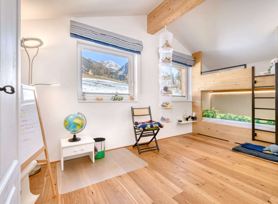 This charming bedroom features a cozy bunk bed, perfect for kids or guests.