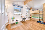 This charming bedroom features a cozy bunk bed, perfect for kids or guests.