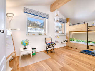 This charming bedroom features a cozy bunk bed, perfect for kids or guests.