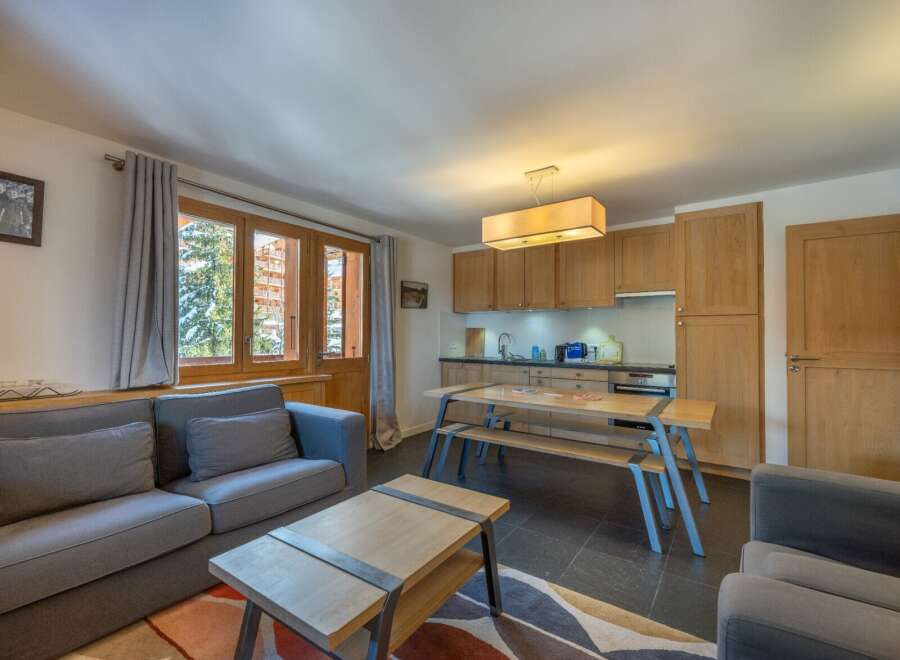 This stunning apartment boasts a spacious living area with comfortable seating and large windows offering breathtaking views.