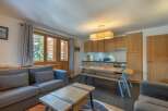 This stunning apartment boasts a spacious living area with comfortable seating and large windows offering breathtaking views.