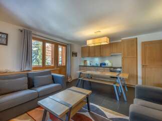 This stunning apartment boasts a spacious living area with comfortable seating and large windows offering breathtaking views.