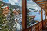 This stunning chalet boasts breathtaking views of the snow-capped mountains and charming village.