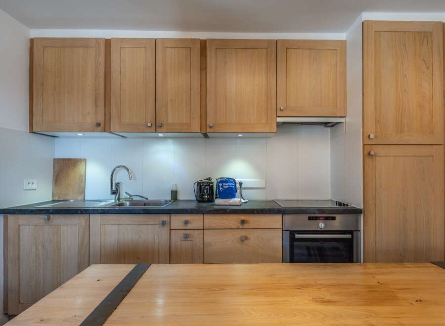 This stunning kitchen boasts modern appliances and ample cabinetry, perfect for preparing delicious meals.