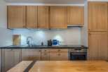 This stunning kitchen boasts modern appliances and ample cabinetry, perfect for preparing delicious meals.