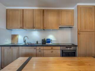 This stunning kitchen boasts modern appliances and ample cabinetry, perfect for preparing delicious meals.