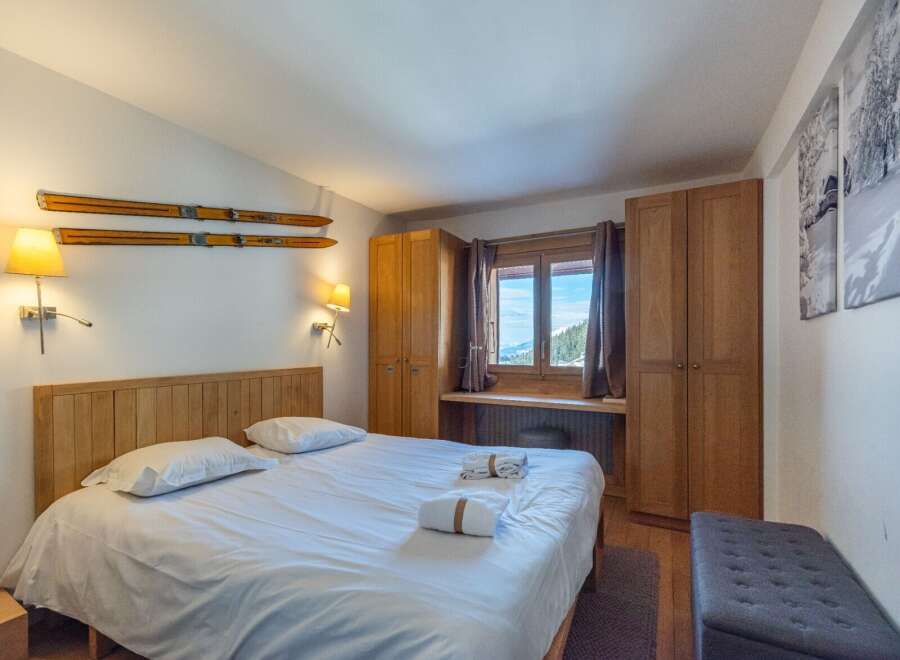 Cozy bedroom with wooden accents and mountain views.