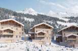 Discover luxurious chalets nestled in a breathtaking snowy mountain setting.