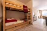 Cozy wooden bunk beds with built-in drawers provide comfortable sleeping arrangements in this charming chalet.