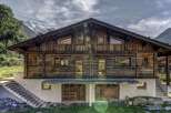 This stunning chalet boasts a rustic-chic design, with exposed wooden beams and large windows offering breathtaking mountain views.