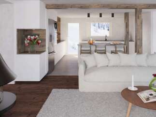 This stunning property boasts an open-concept living area with a cozy white sofa and a modern kitchen featuring sleek stainless steel appliances.