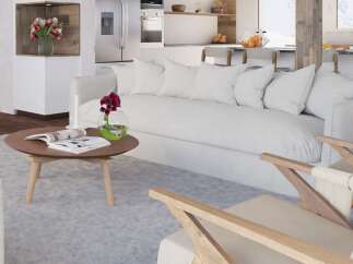 Stunning living room with a cozy white sofa and wooden armchairs, perfect for relaxing after a day on the slopes.