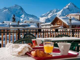 Enjoy a delightful breakfast on your balcony overlooking breathtaking snow-capped mountains.