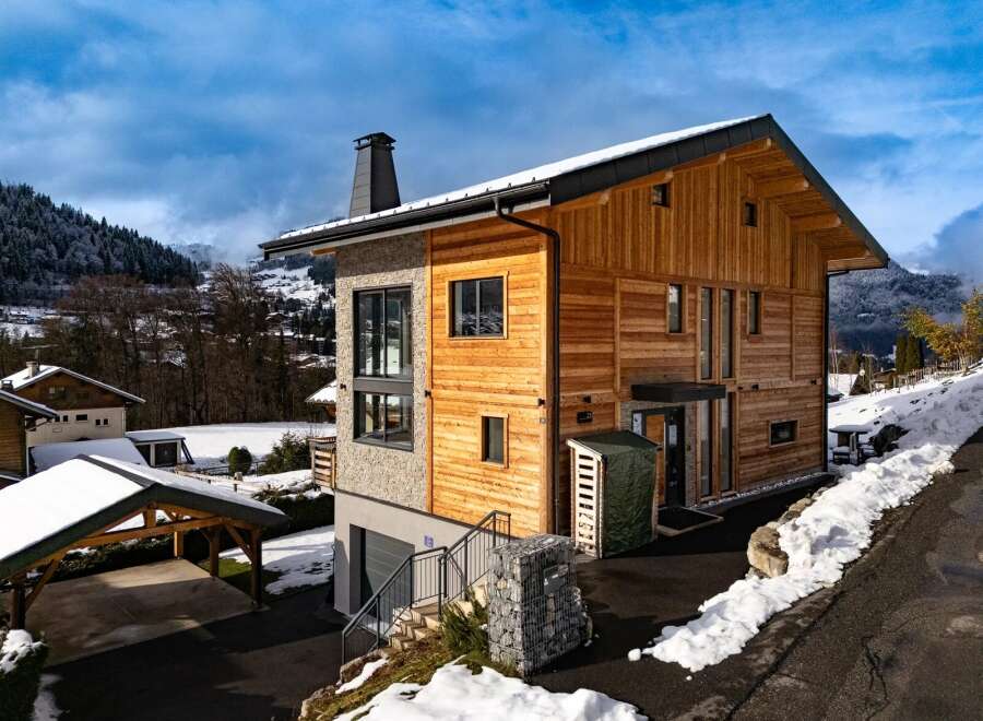 This stunning modern chalet offers a perfect blend of contemporary design and natural beauty.