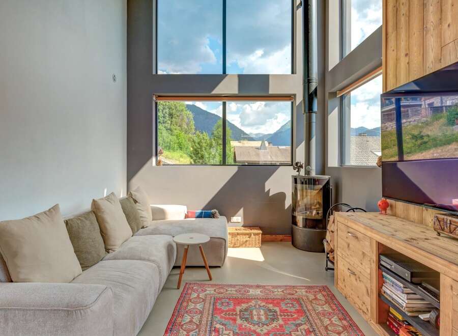 Experience modern living with stunning mountain views in this spacious living area.