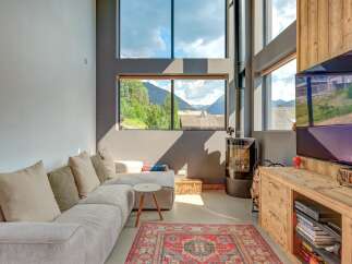 Experience modern living with stunning mountain views in this spacious living area.