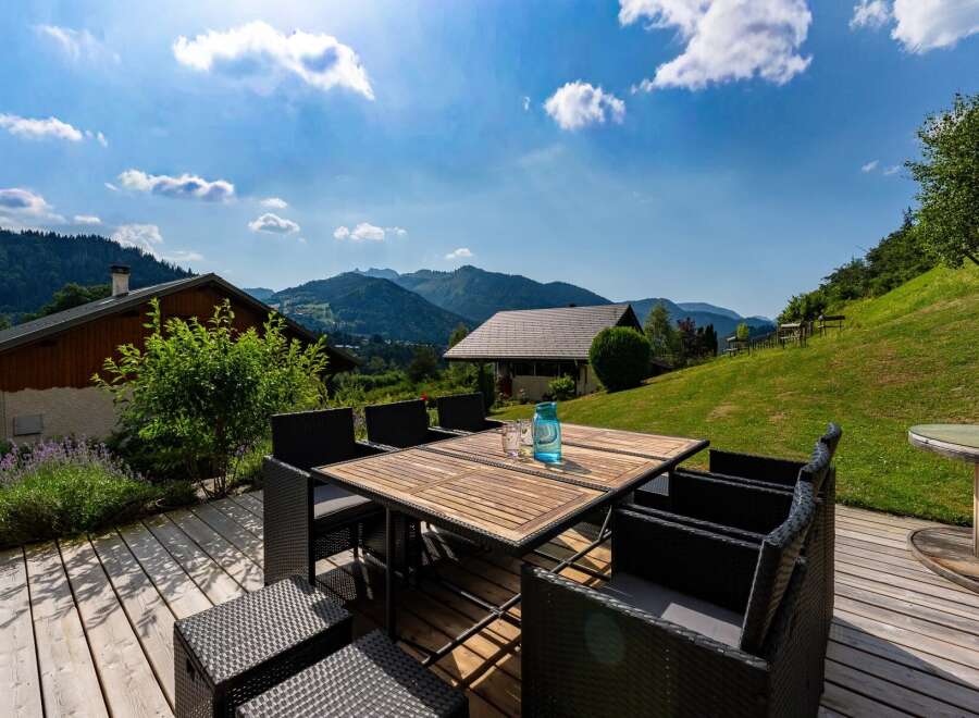 Enjoy breathtaking mountain views from this stunning outdoor patio, perfect for al fresco dining or relaxing with a drink.