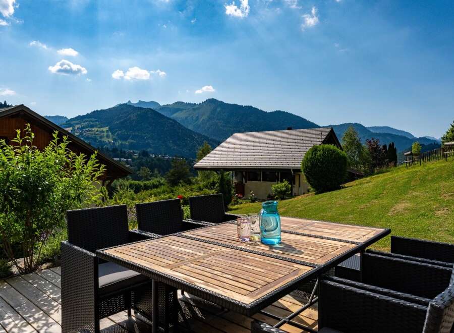Enjoy breathtaking mountain views from this stunning property's outdoor dining area.