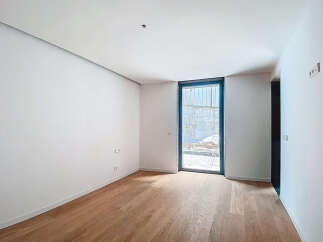 This stunning property boasts a spacious, bright room with gleaming hardwood floors and crisp white walls.