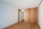 This stunning property boasts a spacious bedroom with sleek, modern hardwood floors and built-in wooden closet.