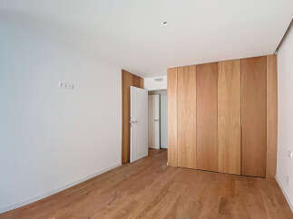 This stunning property boasts a spacious bedroom with sleek, modern hardwood floors and built-in wooden closet.