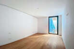 This stunning property boasts a spacious, bright room with gleaming hardwood floors and crisp white walls.