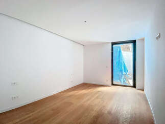 This stunning property boasts a spacious, bright room with gleaming hardwood floors and crisp white walls.