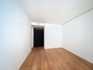 This stunning property boasts a spacious, bright room with gleaming hardwood floors and crisp white walls.