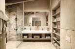 This luxurious bathroom boasts a spacious design with a double vanity, a walk-in shower, and ample storage.