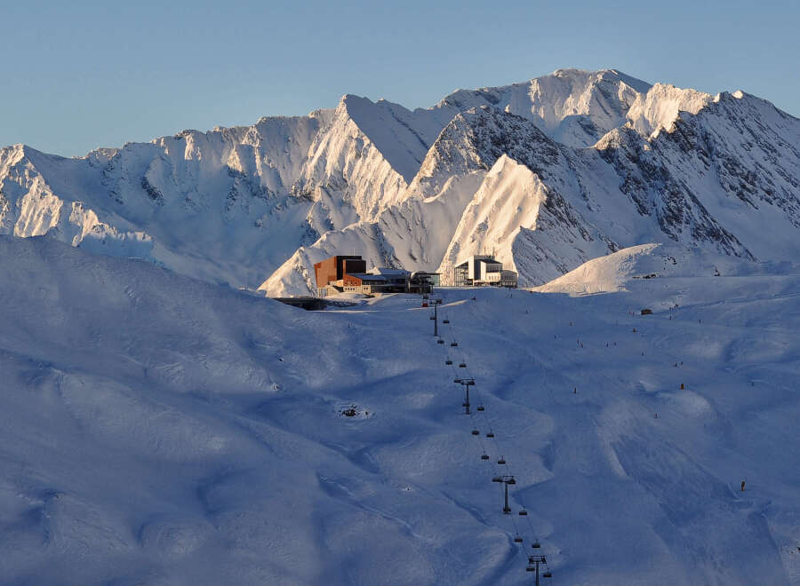 Ski resort nestled in the snow-capped mountains, offering breathtaking views and various slopes for all skill levels.