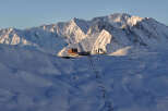 Ski resort nestled in the snow-capped mountains, offering breathtaking views and various slopes for all skill levels.