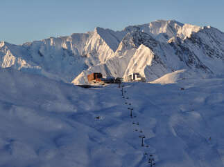 Ski resort nestled in the snow-capped mountains, offering breathtaking views and various slopes for all skill levels.