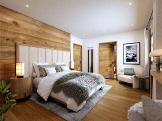 Luxurious mountain retreat boasting a stunning master bedroom with wood paneling, plush bedding, and a cozy seating area.