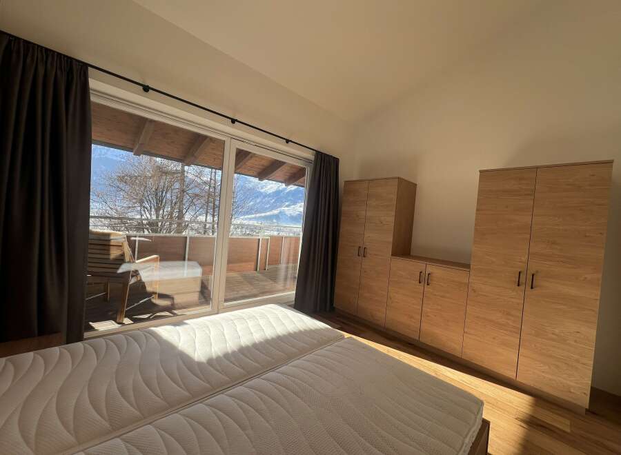 Enjoy breathtaking mountain views from this stunning bedroom.