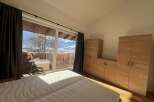 Enjoy breathtaking mountain views from this stunning bedroom.