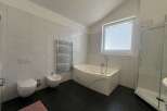 This modern bathroom features a sleek design with a luxurious jacuzzi tub, perfect for relaxation.