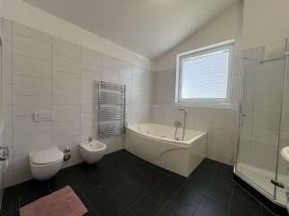 This modern bathroom features a sleek design with a luxurious jacuzzi tub, perfect for relaxation.
