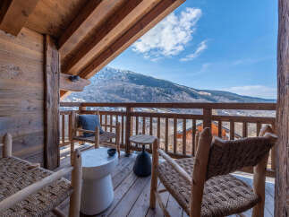 Enjoy breathtaking mountain views from this charming balcony.