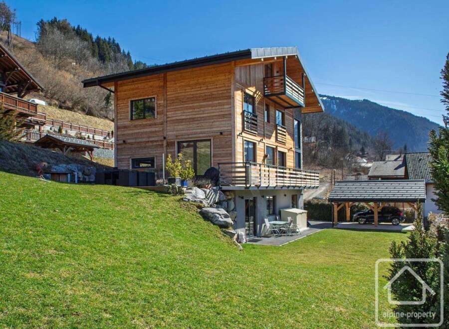 Discover your dream chalet in the heart of the Alps! This stunning property boasts a modern design with wooden accents, offering a warm and inviting atmosphere.