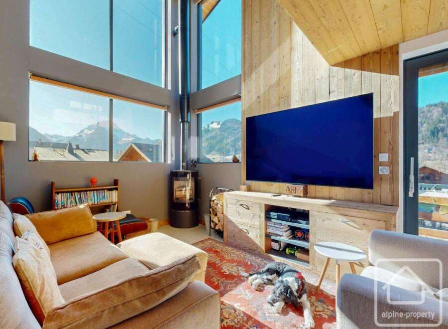 Experience luxury living with this stunning property, boasting breathtaking mountain views visible through expansive windows.