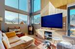 Experience luxury living with this stunning property, boasting breathtaking mountain views visible through expansive windows.