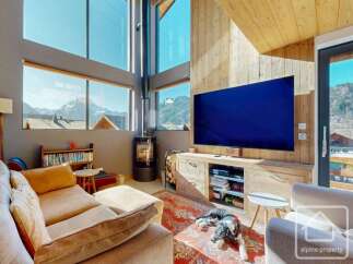 Experience luxury living with this stunning property, boasting breathtaking mountain views visible through expansive windows.