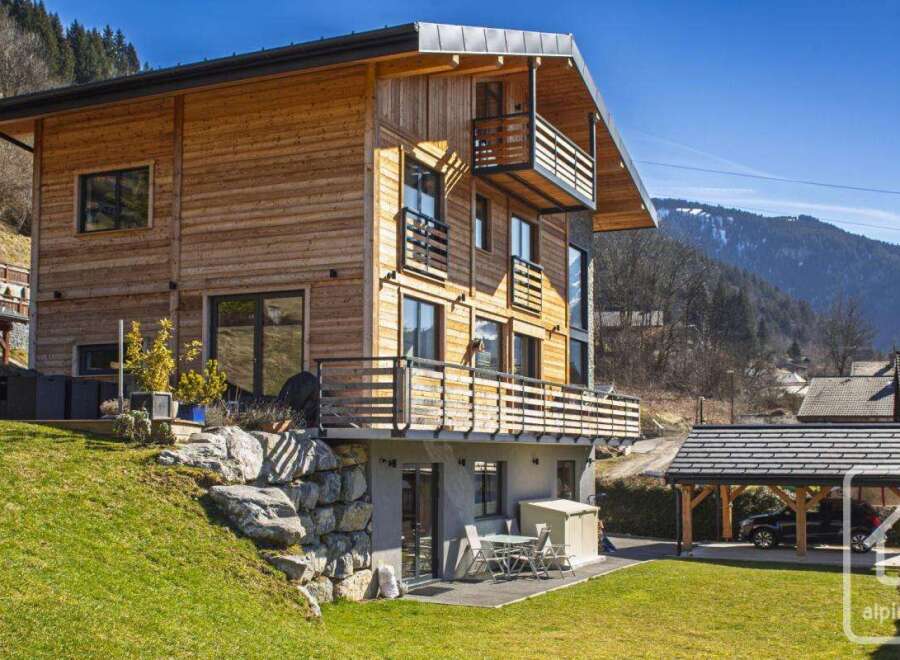 Discover this stunning wooden chalet nestled in a picturesque mountain setting.