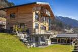 Discover this stunning wooden chalet nestled in a picturesque mountain setting.