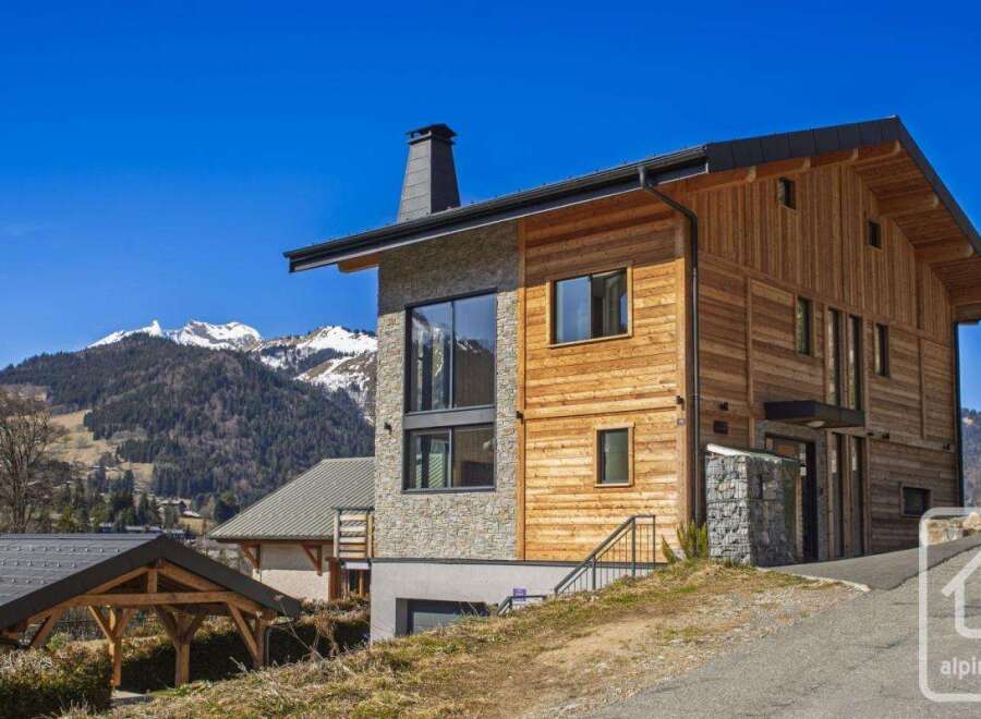 Discover this stunning modern chalet nestled in the heart of the Alps, offering breathtaking mountain views.
