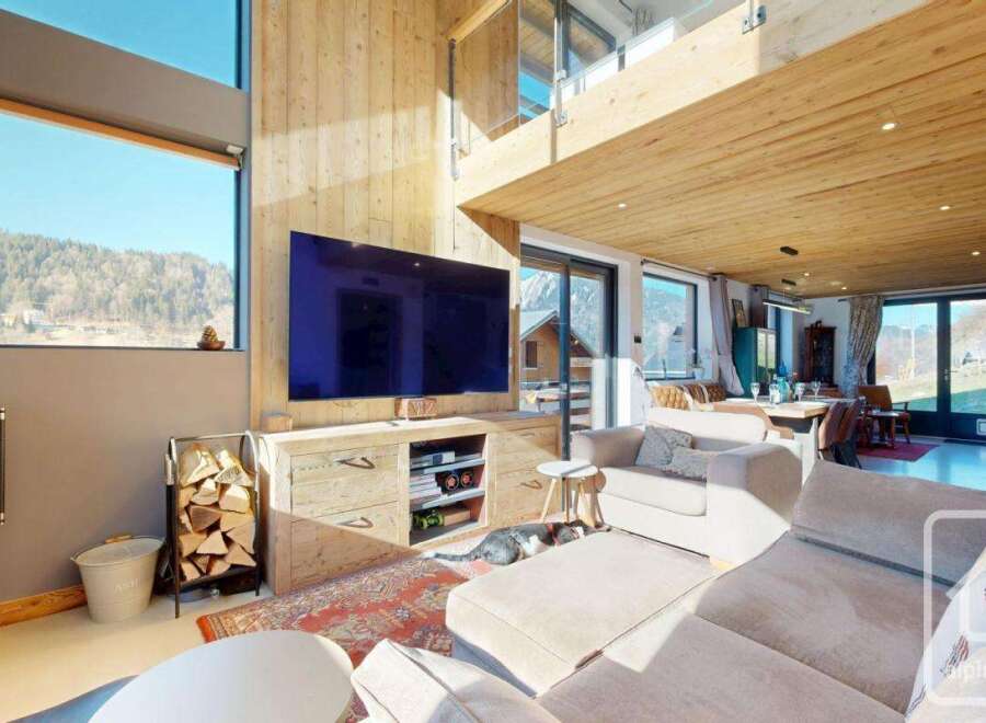 Experience luxury living in this stunning property, featuring a spacious living area with a modern fireplace and a large flat-screen TV.