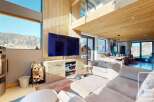 Experience luxury living in this stunning property, featuring a spacious living area with a modern fireplace and a large flat-screen TV.