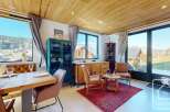 Experience the charm of this stunning property, boasting a beautifully designed dining area with a rustic wooden table and comfortable seating.