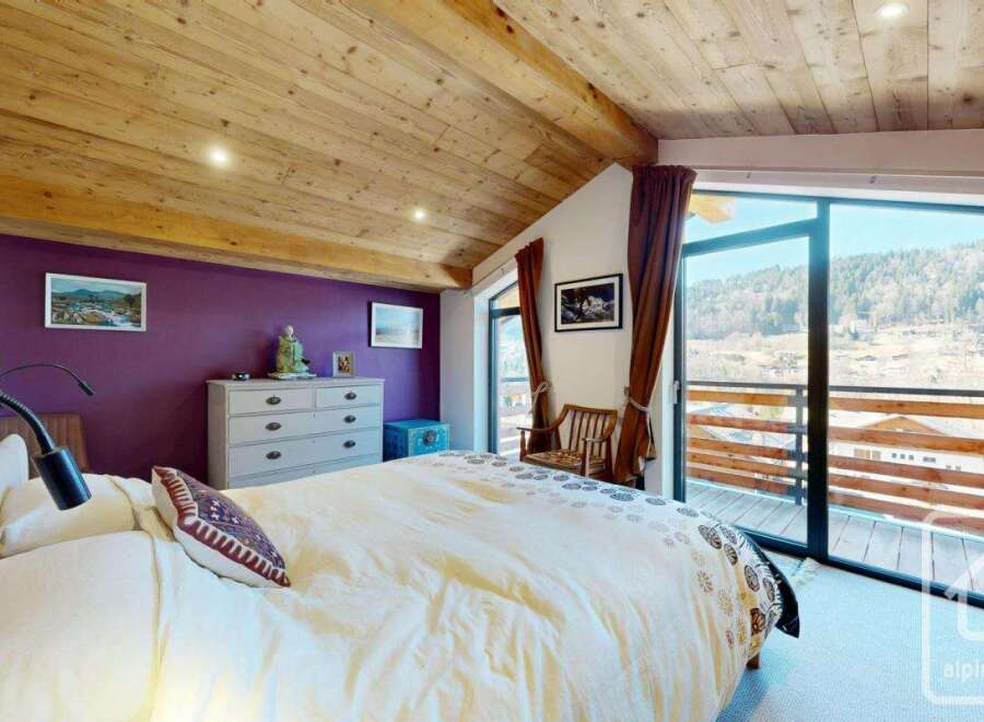 Discover the charm of this stunning bedroom, featuring a cozy bed and a beautiful view.