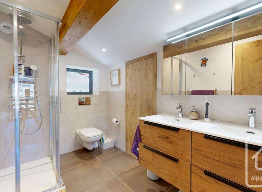 This stunning bathroom boasts a modern design with a touch of rustic charm.